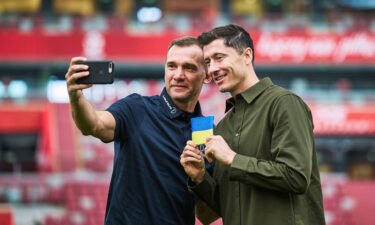 Poland captain Robert Lewandowski (right) received a Ukraine armband from Andriy Shevchenko.