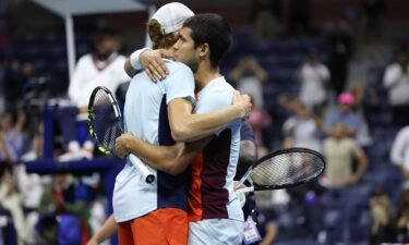 Alcaraz (right) and Sinner embrace after their marathon quarterfinal at the US Open.