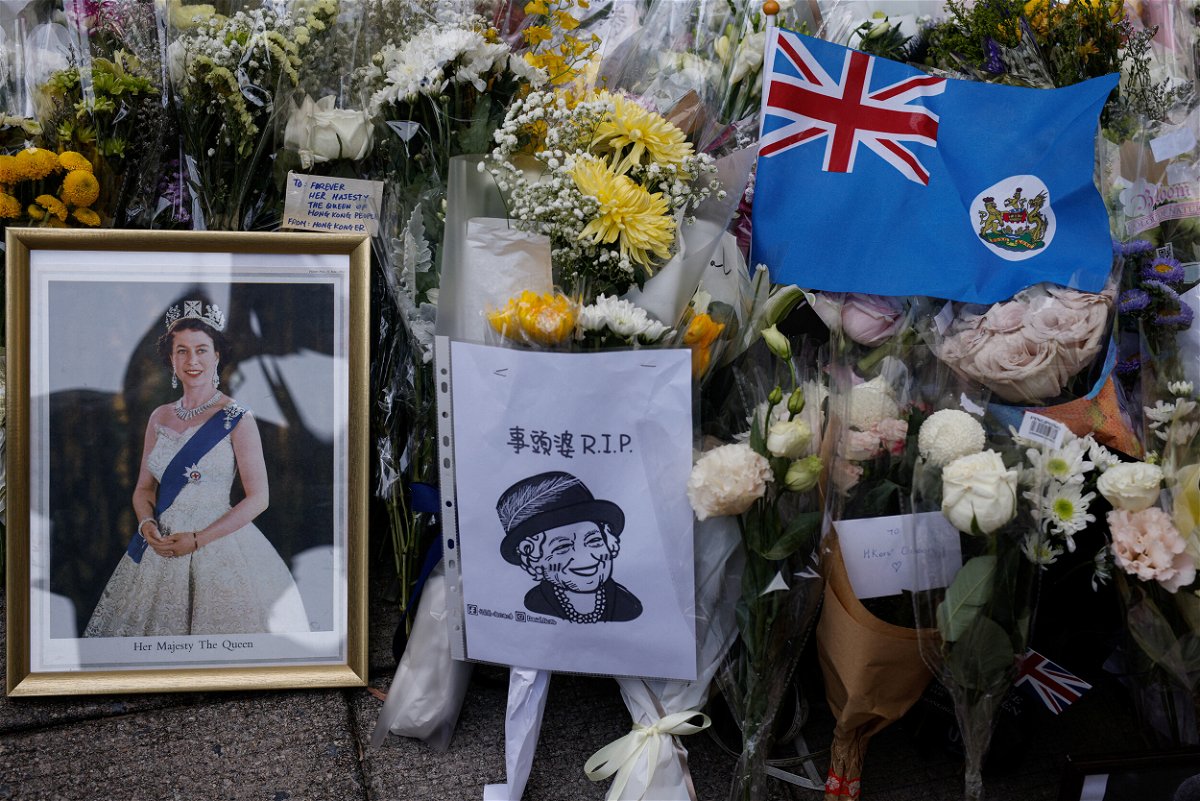 <i>Tyrone Siu/Reuters</i><br/>Mourners placed colonial flags and images of the Queen outside the British consulate in Hong Kong on September 12.