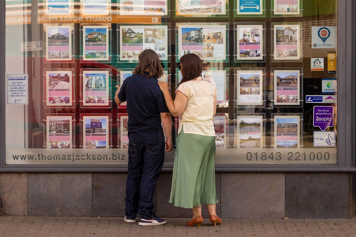 <i>Jason Alden/Bloomberg/Getty Images</i><br/>House prices in the United Kingdom could plummet by as much as 15% if the country presses ahead with its tax-slashing economic gamble. Pedestrians are seen here looking at properties listings in an estate agents window in Margate