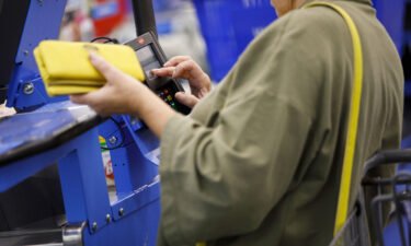 A customer uses a credit card terminal to complete a purchase at a Wal-Mart Stores Inc. location in Burbank
