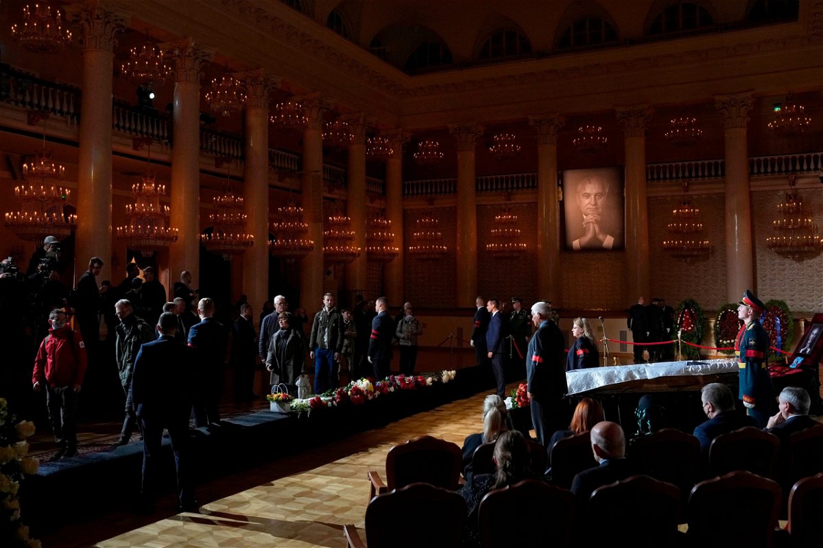 <i>Alexander Zemlianichenko/AP</i><br/>People walk past the coffin of former Soviet President Mikhail Gorbachev inside the Pillar Hall of the House of the Unions during a farewell ceremony in Moscow