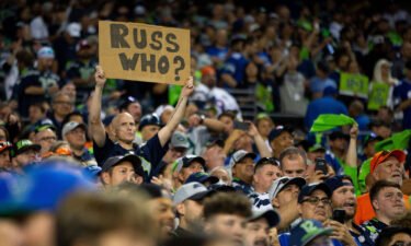 A Seattle Seahawks fan holds a sign referencing Russell Wilson during the second half.