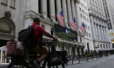 US stock futures were set to fall sharply as investors continued to worry about even more rate hikes from the Federal Reserve that could land the US economy in a recession. A man is pictured here riding a bike in front of the New York Stock Exchange on September 21.