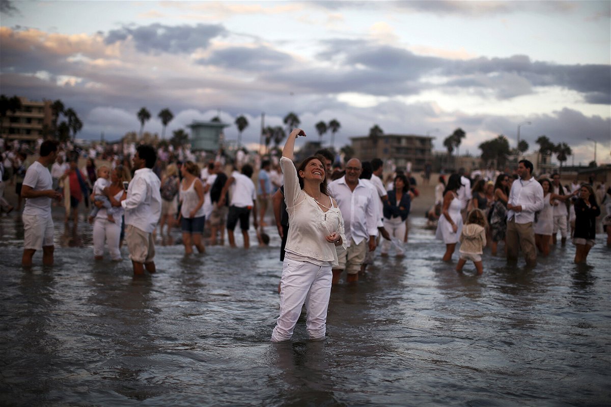 <i>Lucy Nicholson/Reuters</i><br/>Rabbi Naomi Levy throws bread crumbs into the Pacific Ocean at the Nashuva Spiritual Community Jewish New Year celebration on Venice Beach in Los Angeles in 2015.