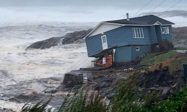 A home fights against high winds caused by post Tropical Storm Fiona in Port aux Basques