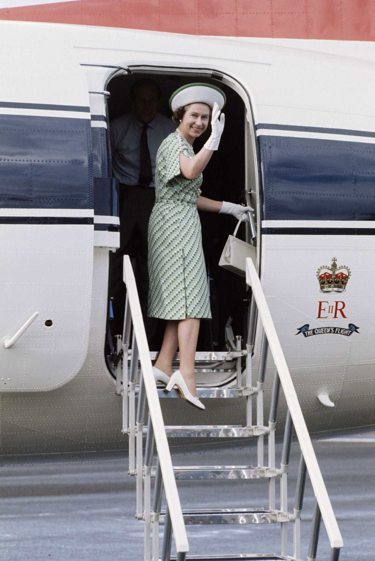 <i>Serge Lemoine/Hulton Royals Collection/Getty Images</i><br/>Queen Elizabeth II leaves Fiji during her royal tour on February 1977. Prince Philip is just visible behind her.