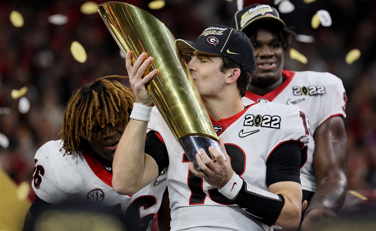 <i>Andy Lyons/Getty Images</i><br/>Stetson Bennett of the Georgia Bulldogs celebrates with the National Championship trophy on January 10. The College Football Playoff Board of Managers has unanimously approved expanding the current four-team playoff format to include 12 schools.