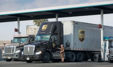 A UPS truck driver locks his vehicle at a truck stop near Interstate 5 in  2021