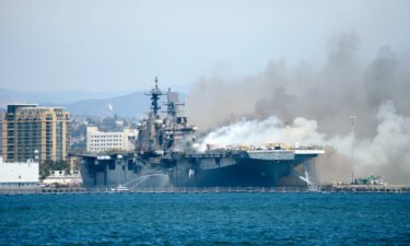 Port of San Diego Harbor Police Department boats combats a fire at Naval Base San Diego on July 12. A sailor charged in connection with starting a fire that destroyed a Navy warship while it was docked in San Diego has been found not guilty.