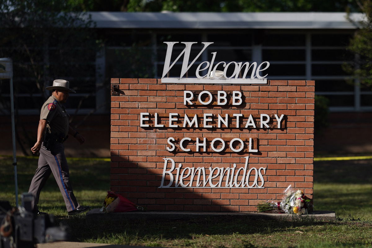 <i>Allison Dinner/AFP/Getty Images</i><br/>An officer walks outside Robb Elementary School in Uvalde