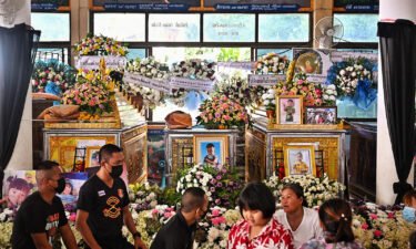 Relatives gather in front of the coffins of victims of the daycare mass shooting at Wat Rat Samakee temple in northeastern Nong Bua Lam Phu province on October 9.
