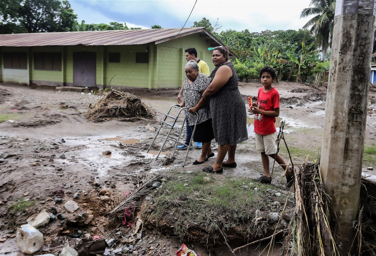 <i>Wendell Escoto/AFP/Getty Images</i><br/>Residents leave their house at the former banana fields of the municipality of El Progreso before the arrival of tropical storm Julia