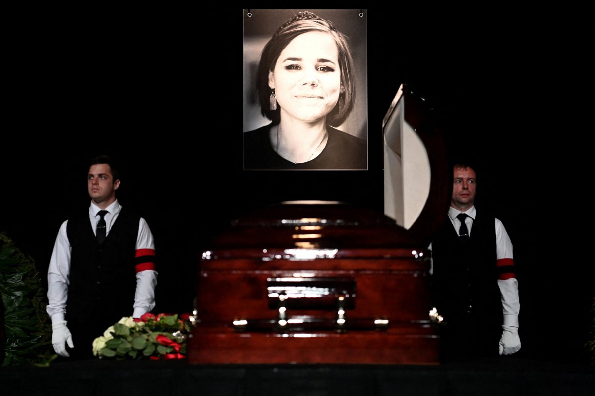 A portrait of Russian Daria Dugina, who was killed in a car bomb explosion the previous week, is displayed near her coffin during a farewell ceremony at the Ostankino TV centre in Moscow on August 23, 2022. - 