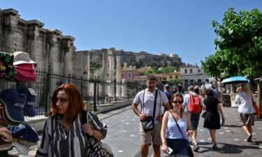 Tourists and locals walk in a touristic area of Athens on June 1. The CDC will no longer maintain a country-by-country list of travel advisories related to Covid-19.