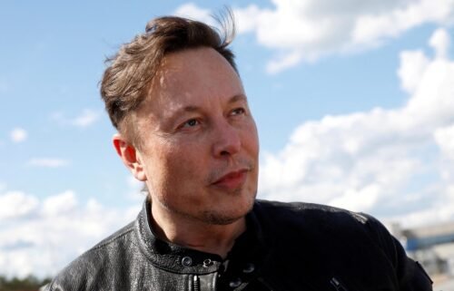 Tesla CEO Elon Musk looks on as he visits the construction site of Tesla's factory in Gruenheide