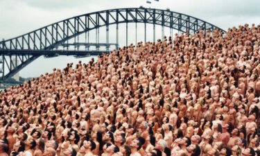 Artist Spencer Tunick is once again asking thousands of volunteers to get naked for one of his iconic mass nude photo shoots. Thousands are pictured here by the Sydney Harbor Bridge for Tunick's shot in 2010.