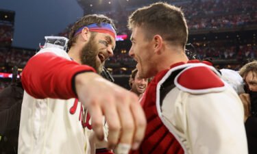 Bryce Harper of the Philadelphia Phillies celebrates with J.T. Realmuto after defeating the San Diego Padres in Game 5 to win the National League Championship Series on October 23