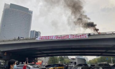 A banner is seen on Sitong Bridge in Beijing on October 13.