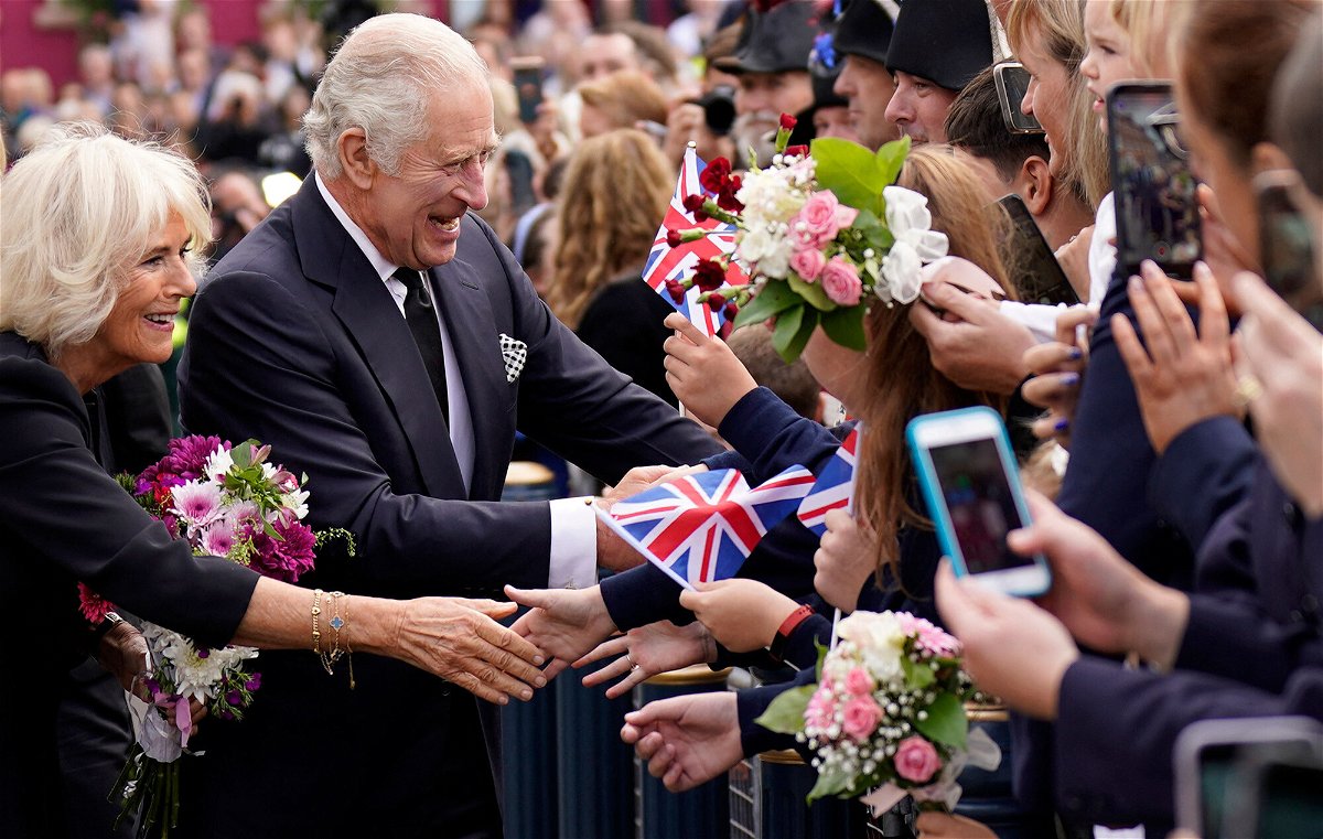 <i>Niall Carson/AFP/Getty Images</i><br/>King Charles III and Queen Consort Camilla greet well-wishers as they arrive at Hillsborough Castle in Belfast on September 13.
