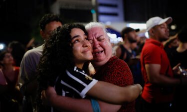 Supporters of Lula da Silva react as they wait for results in Sao Paulo