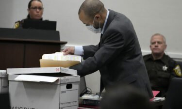 Darrell Brooks looks through files during the his trial in Waukesha County Circuit Court in Waukesha