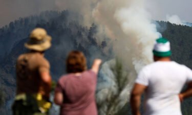 Europe is warming faster than any other region. Residents watch as a column of smoke emerges from a forest fire in Galicia