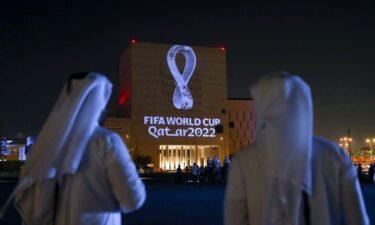 Qataris gather at Doha's traditional Souq Waqif market as the official logo of the 2022 World Cup is projected on a building in September 2019.