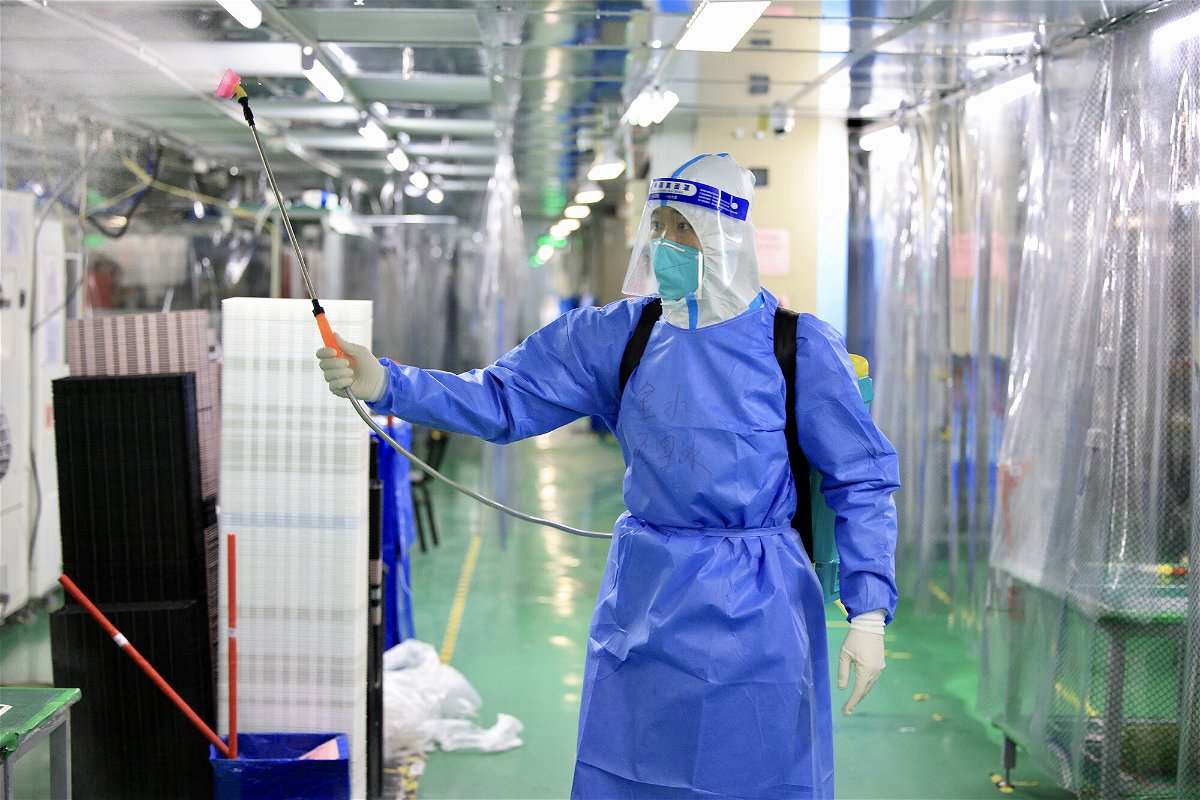 <i>VCG/Getty Images</i><br/>The bonuses are part of a recruitment drive aimed at getting iPhone production back on track at the Foxconn plant after a Covid lockdown. A staff member disinfects a factory on November 6 in Zhengzhou