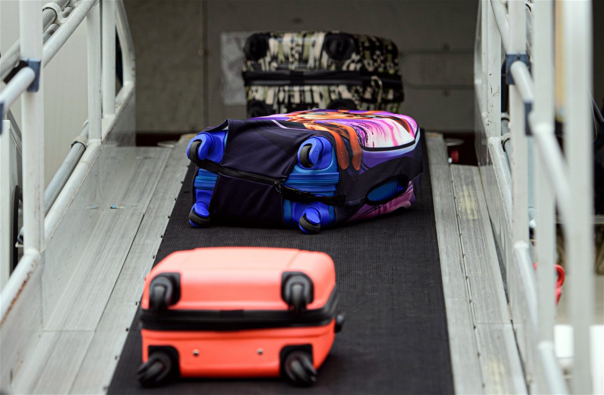 <i>Robert Michael/picture alliance/Getty Images</i><br/>Suitcases roll onto a Sundair A320 aircraft at Dresden International Airport in Germany. Take a photograph of your luggage. It could come in handy later.
