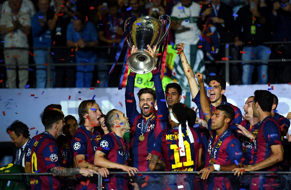 <i>Shaun Botterill/Getty Images</i><br/>Piqué lifts the Champions League trophy after Barcelona won the competition in 2015.