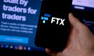 Bitcoin has plummeted about 65% so far this year. This photo shows the logo of FTX with a screen showing their website in the background in Arlington