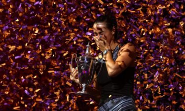 Caroline Garcia celebrates with the WTA Finals trophy after beating Aryna Sabalenka on November 7 in Fort Worth