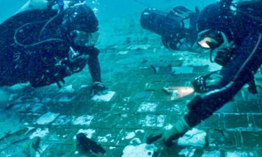 Marine biologist Mike Barnette and diver Jimmy Gadomski explore a segment of the 1986 Space Shuttle Challenger found off the Florida coast during the filming of "The Bermuda Triangle: Into Cursed Waters."