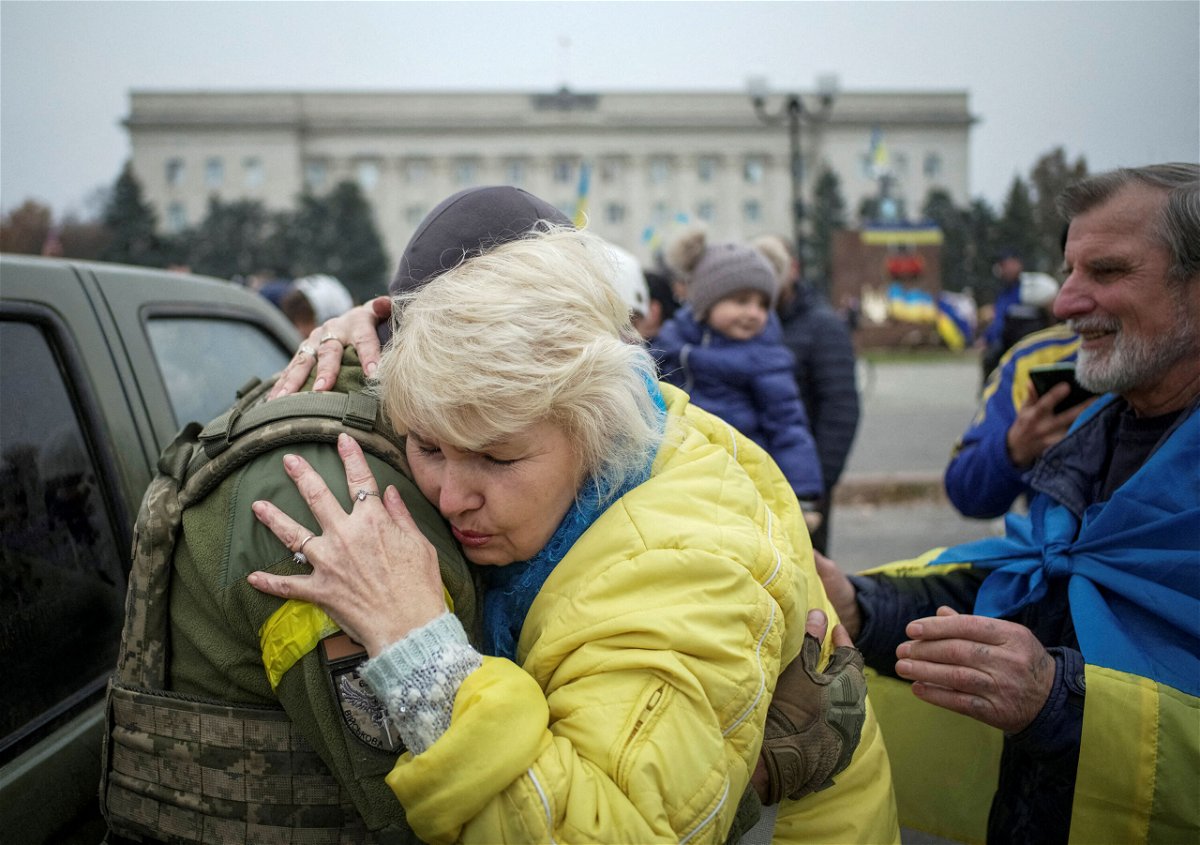 <i>Lesko Kromplitz/Reuters</i><br/>A local hugs a Ukrainian serviceman as people celebrate after Russia's retreat from Kherson city