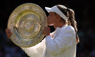 Elena Rybakina of Kazakhstan celebrates with the trophy after victory against Ons Jabeur of Tunisia during the Ladies' Singles Final match of The Championships Wimbledon 2022 on July 9 in London.