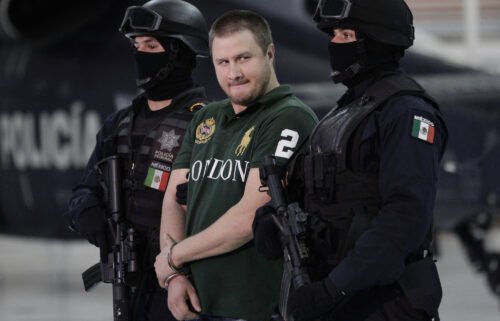 Edgar "La Barbie" Valdez Villareal is escorted by Mexican federal police during a news conference at the federal police center in Mexico City in August 2010. According to the Federal Bureau of Prisons