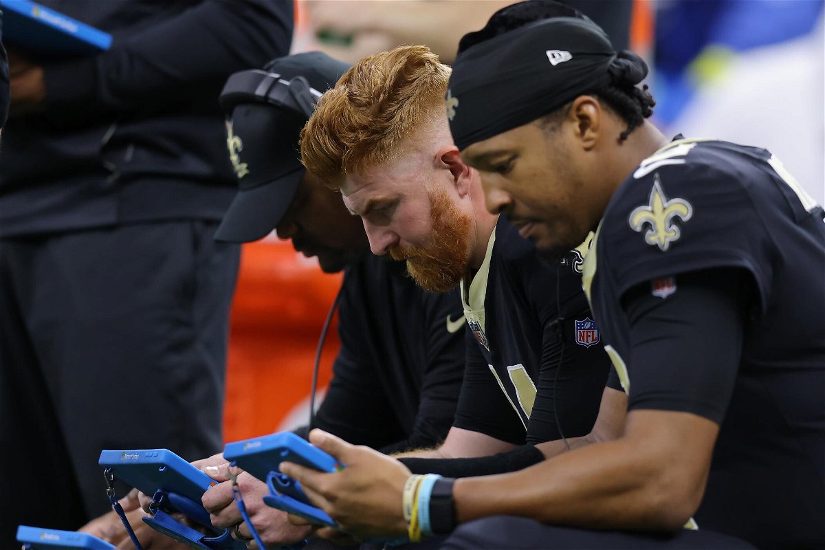 <i>Jonathan Bachman/Getty Images North America/Getty Images</i><br/>Andy Dalton (left) and backup quarterback Jameis Winston look at tablets during the second quarter against the Ravens on November 7.