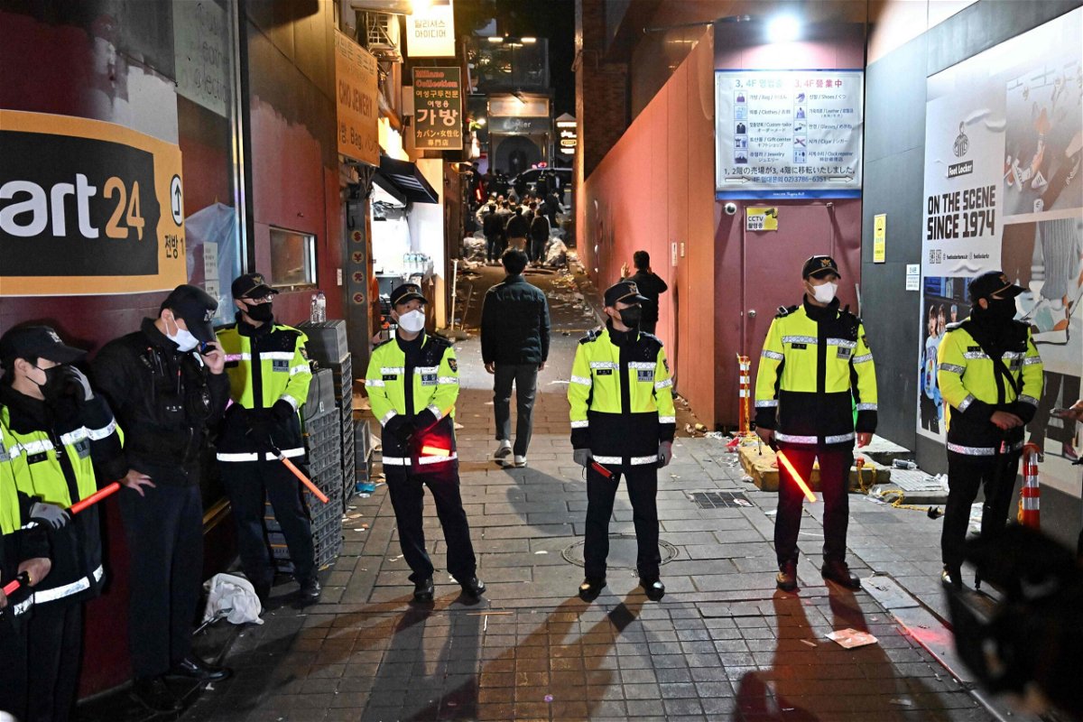 <i>Jung Yeon-Je/AFP/Getty Images</i><br/>Police stand guard at the scene of the crowd crush in Seoul