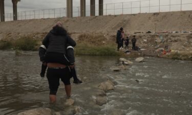 A group of migrants cross the Rio Grande into the US from Ciudad Juarez at the Mexico-US border.