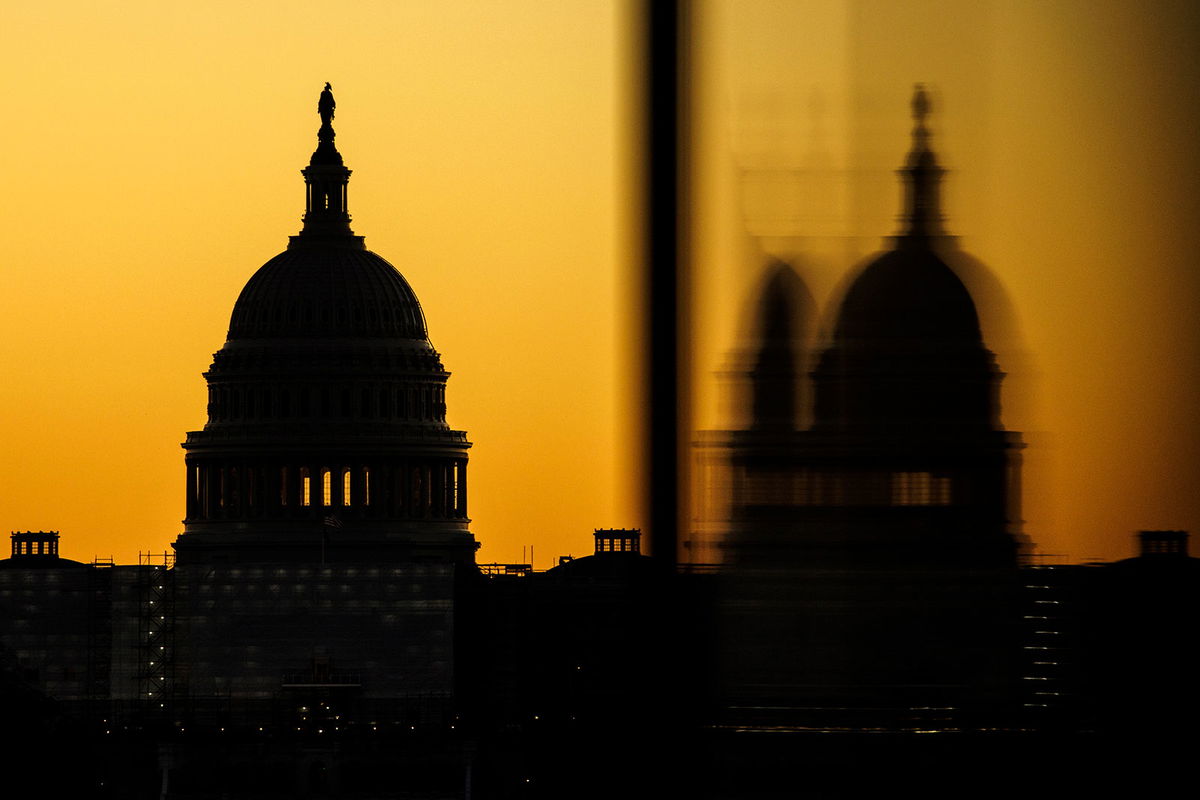 WASHINGTON, DC - NOVEMBER 09: The US Capitol dome is seen from the base of the Washington Monument as the sun rises on November 9, 2022 in Washington, DC. Americans participated in the midterm elections to decide close races across the country after months of candidate campaigning. (Photo by Samuel Corum/Getty Images)