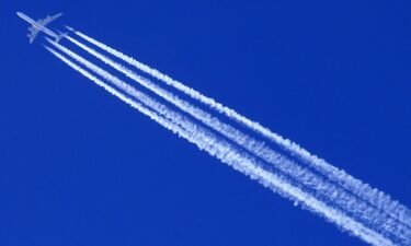 A Qatar Airways Airbus A340 airplane leaves contrails in the sky.