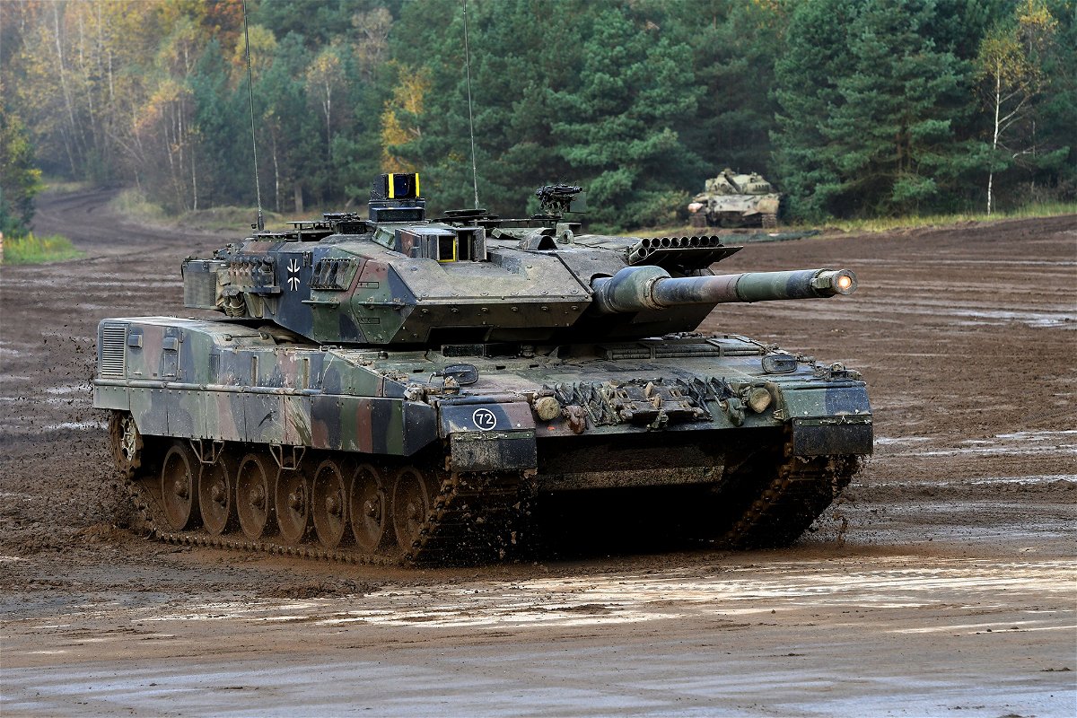A Leopard 2 A7 main battle tank of the German armed forces Bundeswehr drives through the mud in the context of an informative educational practice 