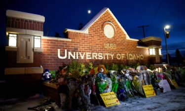 A memorial for four students found dead in their residence is seen in front of a University of Idaho campus sign