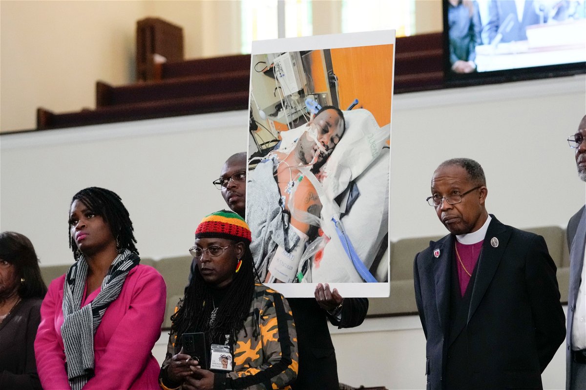 <i>Gerald Herbert/AP</i><br/>Family members and supporters hold a photograph of Tyre Nichols at a news conference in Memphis