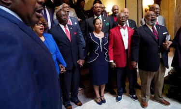 Members of the Mississippi Legislative Black Caucus hold hands and sing "We Shall Overcome" following a news conference where they expressed disappointment at the passage of House Bill 1020.