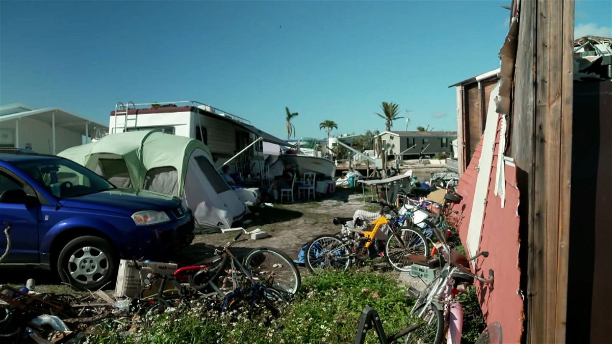 <i>CNN</i><br/>In the shadow of Lee McCall's crumbled home sits an old RV and two tents that are now housing her family.