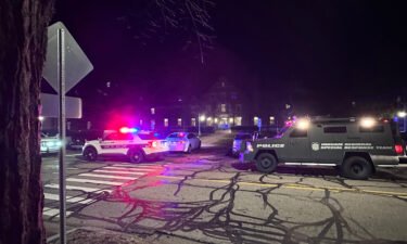 Police and emergency vehicles sit on Michigan State University's campus as police search for an active shooter on February 13.