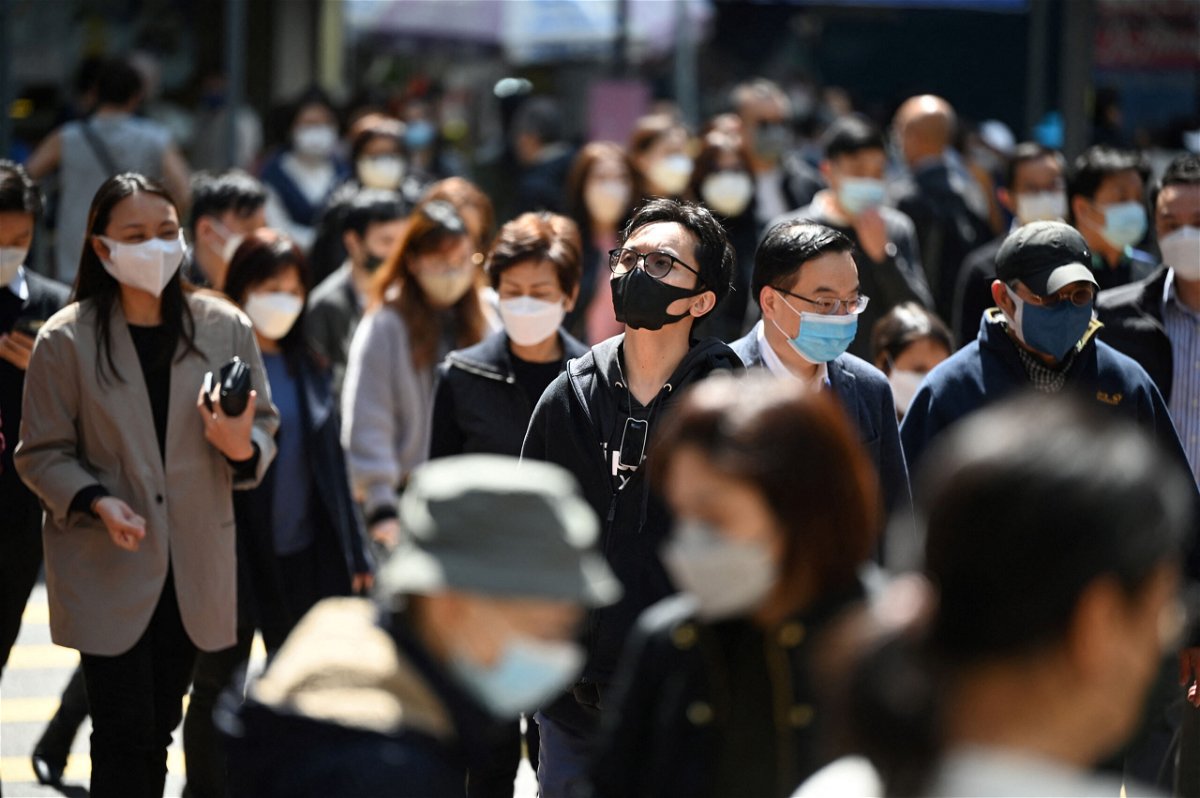 People wear masks on a street in Hong Kong on February 27, 2023 as health experts in the territory backed the extension of its mask mandate to March 8 leaving Hong Kong as one of the only places left in the world with such rules. (Photo by Peter PARKS / AFP) (Photo by PETER PARKS/AFP via Getty Images)