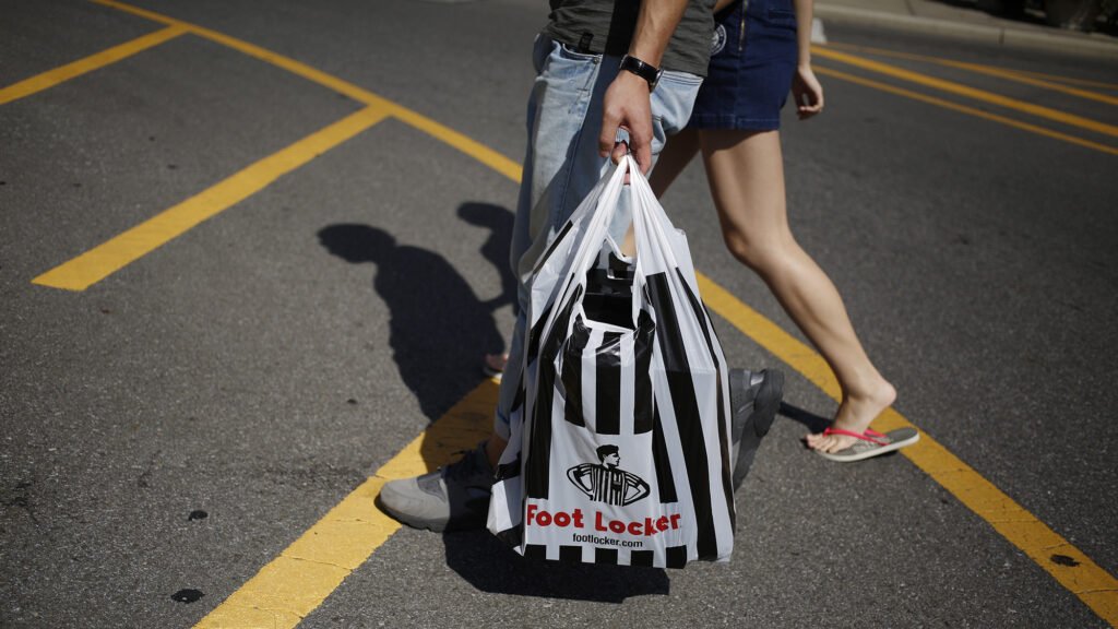 A pedestrian carries a Foot Locker Inc. bag at the Easton Town Center shopping mall in Columbus, Ohio, U.S., on Tuesday, Aug. 23, 2016. The Conference Board is scheduled to release consumer confidence data on Aug. 30. Photographer: Luke Sharrett/Bloomberg via Getty Images